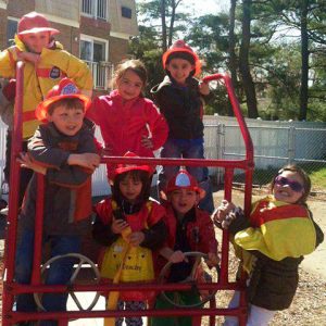 A group of children play firemen.
